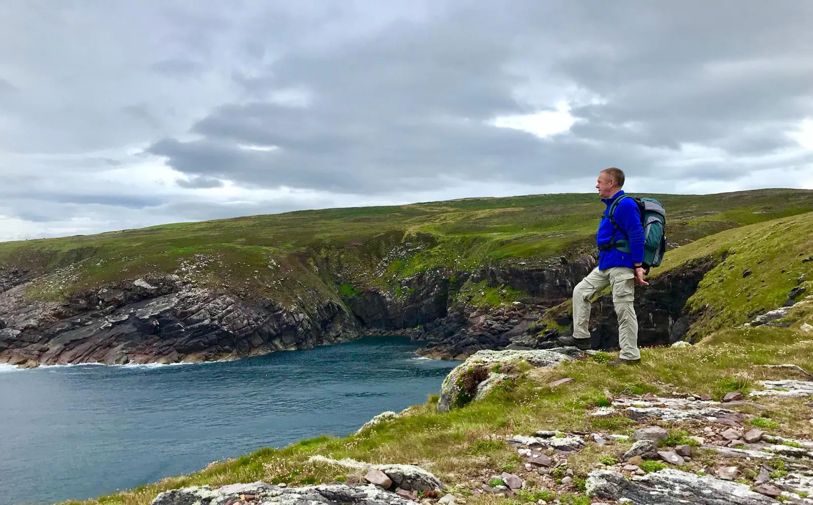 A club member looking out over sea cliffs